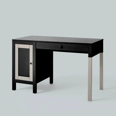 Modern black desk with metal legs, one drawer, and storage cabinet against a light gray background.