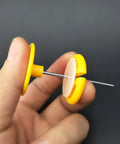 82 Piece Plastic Gear Kit For DIY Toy Cars And Robots, close-up of yellow gear and axle in hand.