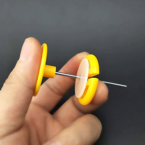 82 Piece Plastic Gear Kit For DIY Toy Cars And Robots, close-up of yellow gear and axle in hand.