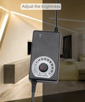 Plug And Play Adjustable Power Supply 100-240V AC To DC 3-12V 2A 24W Dimmer Transformer shown adjusting room lighting