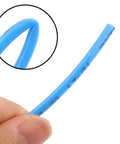 Close-up of Blue PU Tubing 4Mm OD 2.5Mm ID For Pneumatic Hoses Air Compressor Pipe held in hand, showing flexibility.