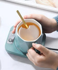 Rapid Heat Electric Cup Warmer Locks Your Favorite Brew Piping Hot Through The Entire Grind Temp Control Pad with teal mug and spoon.