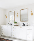 Matte Black 4 Inch Centerset Bathroom Faucet With Two Handles Pop Up Drain And Supply Lines Solid Brass Construction No Fuss Install Spot Resistant Finish ADA NSF cUPC Certified installed on white double vanity in bright bathroom