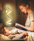 Woman reading to child at night with Spiral LED Desk Lamps Set Of 2 10W Modern Bedside Lights softly illuminating the room.
