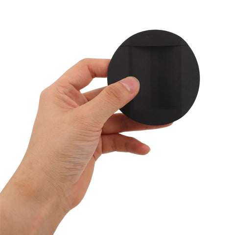 Hand holding heavy duty round rubber non slip furniture pad for chairs and furniture feet skid proof floor protectors for hardwood and wooden floors