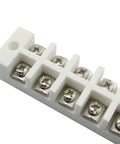 Six-position white porcelain terminal block with screw terminals; angled view