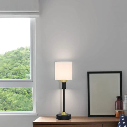Mid Century Modern Table Lamp With USB Port And Fabric Shade In Black And Gold on wooden desk, near window