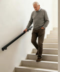 Heavy Duty Stainless Steel Flush Wall Mounted Handrail Matte Black Stair Railing used by a man on stairs for secure grip and safety.