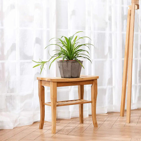 Bamboo Shower Bench 19 Inch Waterproof Shower Chair With Storage Shelf, used as a plant stand, in an indoor setting