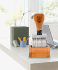Kickin Retro Wooden Roller Date Stamp With Sleek Grip And Clean Roll On Ink System, natural wood handle, office setup.
