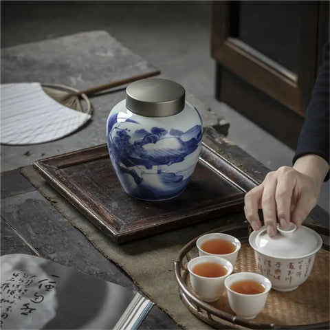 Solid Ceramic Tea Canister For Loose Leaf Storage, Airtight Kitchen Jar displayed on a tray with tea cups.
