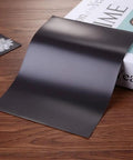 Scrapblooms Portable Electric Die Cut And Embossing Machine Kit For Automatic A4 Crepe Paper Flower Making Card Craft includes black magnetic sheet on wooden table.
