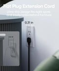 Flat plug extension cord shown behind furniture for space-saving in a modern office setup, featuring dimensions of 0.31 in thick.