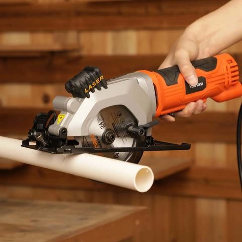 Yunirvana mini circular saw, side view, with laser guide and orange housing cutting PVC pipe.