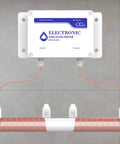 Whole House Salt Free Water Softener Descaler System for Hard Water mounted on wall with copper wiring.