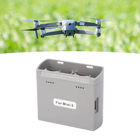 Two Way Battery Charger Hub For Mini 4K Mini 2 Mini SE And Mini 2 SE Drones with USB Power Adapters in front of a flying drone