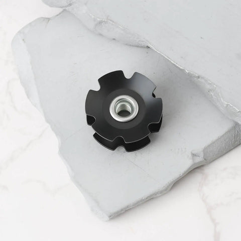 Two Pack Bicycle Front Fork Bowl Star Nuts For One And A Quarter Inch Diameter Forks With M6 Threads And Twenty Nine Point Four Millimeters Width, black finish on concrete surface