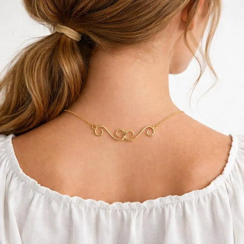 Woman wearing necklace with gold swirl S-hook extender, part of Set Of 4 S Hook Necklace Extenders With Gold And Silver Swirl Hooks
