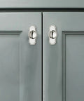 Five Pack Heavy Duty Polished Nickel Cabinet Knobs And Backplates on grey kitchen cabinet doors, showcasing their vintage style.