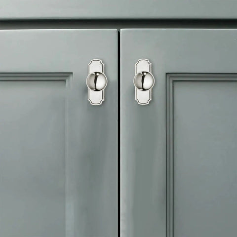 Five Pack Heavy Duty Polished Nickel Cabinet Knobs And Backplates on grey kitchen cabinet doors, showcasing their vintage style.