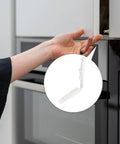 Hand reaching for a cabinet using Upgrade Your Cupboards With These Durable White Plastic Rebounders For Easy Push To Open.
