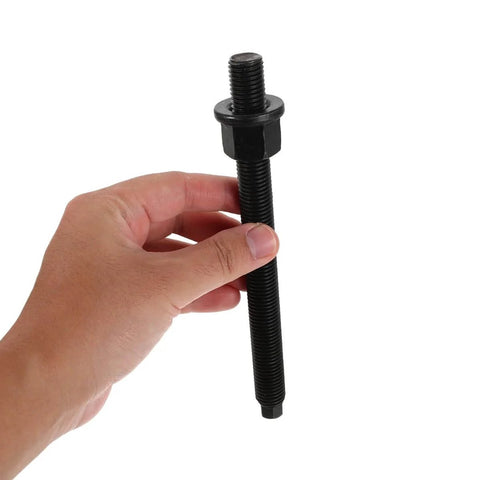Hand holding Crankshaft Pulley Puller Tool Kit With Bearing Removal For Automotive Engine Repair Drive Pulley Remover And Timing Gear Puller Pro Grade Heavy Duty Tool For Pros And DIY Car Maintenance