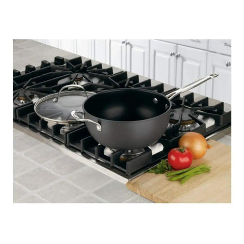 Chef's Classic Nonstick Hard Anodized 4-Quart Pan With Helper Handle And Glass Lid on stovetop beside vegetables.