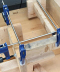 Professional Grade Eighteen Inch F Clamp Boasts A Smooth Quick Release Lever applied on wooden boards for secure gripping.