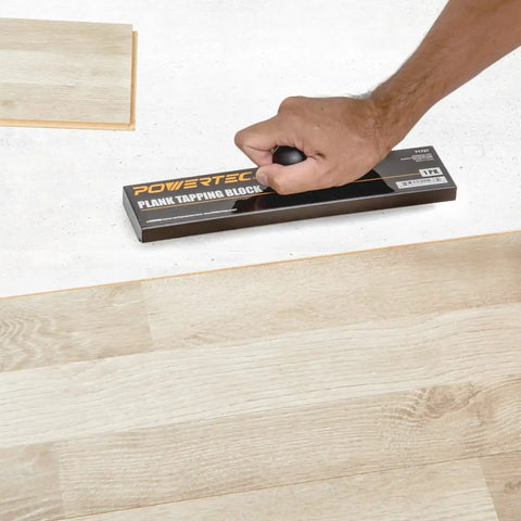 Using No Hammer Needed Tapping Block With Ergonomic Ball Handle for installing laminate, hardwood, and vinyl plank floors.