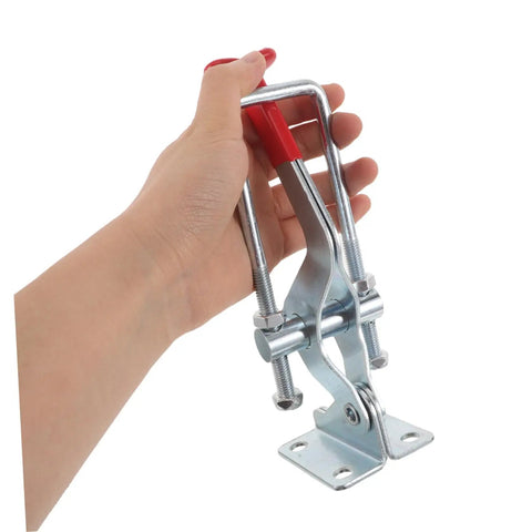 Hand holding Heavy Duty Toggle Latch Clamp for Tool Boxes and Jigs, 2183 Lbs Holding Capacity, Galvanized Iron With Hydrophobic Sealing and Anticorrosive Treatment, Adjustable Metal, Weatherproof Quick Release Design on white background