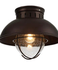 Outdoor Farmhouse Ceiling Light 10 Inch Flush Mount In Oil Rubbed Bronze With Metal Cage And Seeded Glass Semi Entry Hall Light Fixture For Porch Patio Or Foyer, close-up view showing the glowing bulb through seeded glass shade.