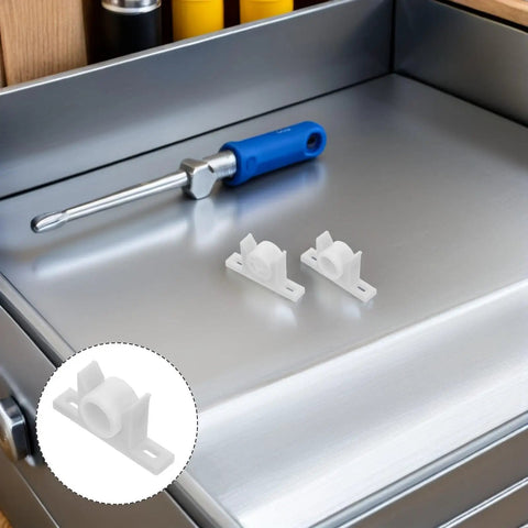 White Plastic Cabinet Door Ball Catches With Screws, 30 Pack, shown on metal surface with screwdriver nearby