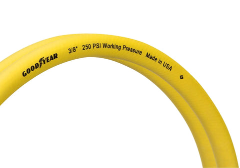 Close-up of the Six Foot By Three Eighth Inch Rubber Whip Hose Yellow 250 PSI With Brass End Fittings And Reinforced Abrasion Resistant Outer Jacket