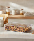 Clear Pet Storage Bin Kick Clutter To The Curb In Style Slick Transparent Plastic Organizer For Pantry Snacks And Desk Essentials Stackable Home Solution To Keep Your Setup Lookin Legit filled with granola on kitchen counter.