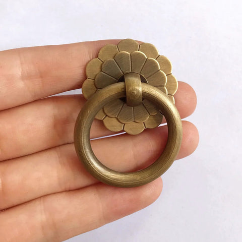 Close-up of Six Pack Vintage Style Brass Ring Pulls Set 2.5 Cm Ring Diameter With 0.87 Inch Screws, solid brass in hand