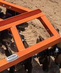 Close-up of 5ft Notched Disc Harrow Attachment For Cat 1 Tractors, 3 Point Implement with concave discs and steel frame in field