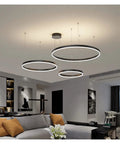 Spacious Circle Pendant Light Built With Heavy Duty Aluminum And Offering Hella Bright White Glow Smooth Rust Proof Finish Great For Large Dining Rooms Kitchens Or Open Lofts Serving Up Top Tier Daily Illumination, featuring three circular designs.