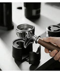 Adjustable Espresso Tamping Station For Home Cafe Setups Fits 51mm 53mm And 58mm Portafilters showing a portafilter with wooden handle.