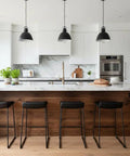 Modern kitchen featuring Warm Rustic Walnut Oil Based Interior Wood Stain on cabinetry and wooden island, with black stools.