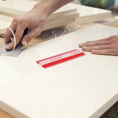 Person using a red self adhesive acrylic folding corner hinge on wood. Self Adhesive Acrylic Folding Corner Hinges 4 Pack Reusable No Drill Door And Cabinet Hardware For Home And Office Clear Durable Build Easy Install For Screens Cabinets And Small Projects DIY Friendly visible.
