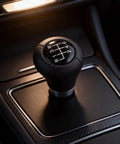 Stylish Red LED 6-Speed Gear Shift Knob For BMW E30 E36 E46 E60 E90 With Cool Glowing Light, ABS Handle For Smooth Manual Shifting And Easy Car Interior Upgrades Tonight. Black 6-speed manual gear shift knob in BMW interior, ABS body