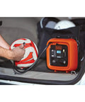 Inflating a soccer ball with 12V DC Multipurpose Inflator With Digital Gauge, High-Volume For Air Mattresses And Rafts, High-Pressure For Car And Bike Tires, Includes Deflate Function For Quick Cleanup, Dope Portable Auto Accessory in car trunk