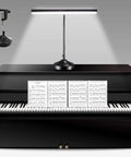 Two In One Piano Desk Lamp With Flexible Gooseneck And Clamp Base, 10W LED Piano Light illuminating a sheet music on a piano