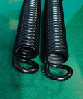 Built Tough Heavy Duty Extension Spring For Serious Torque Jobs And Garage Bay Ready Rigging Upgrades Crafted From Industrial High Strength Steel With Zero Fluff Tension Specs Twenty Inch Overall Length And Two Inch Outer Diameter, black coils side view.