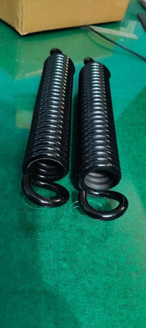 Built Tough Heavy Duty Extension Spring For Serious Torque Jobs And Garage Bay Ready Rigging Upgrades Crafted From Industrial High Strength Steel With Zero Fluff Tension Specs Twenty Inch Overall Length And Two Inch Outer Diameter, black coils side view.