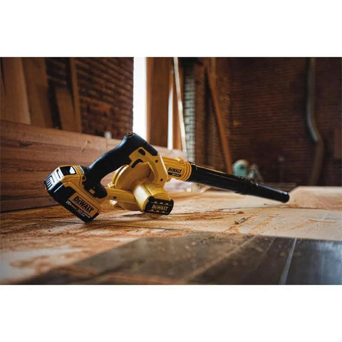 20V Max Cordless Leaf Blower with 100 CFM airflow resting in a workshop, lightweight design with 3 nozzle attachments, trigger lock visible