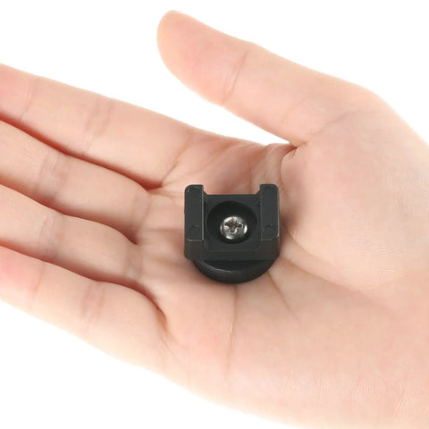 Hand holding a magnetic base from Magnetic Zip Tie Mount Kit 60 Piece For Cable Management With Heavy Duty Nylon Ties And Magnetic Bases