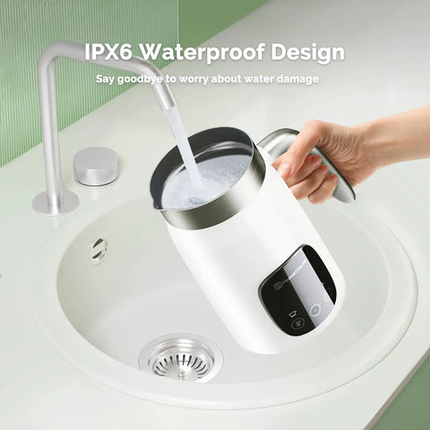 Barista Vibe DualFro 400 Milk Frother being rinsed under a faucet, demonstrating its IPX6 waterproof design.