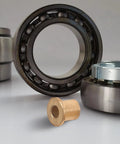 Six Piece Flanged Copper Sleeve Bearings With Step Shoulder Flange And Wrapped Brass Bushings Built Like A Tank For Heavy Equipment Workshops And Slick High Speed Motor Shafts.