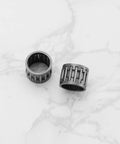 Two Pack Clutch Sprocket Needle Bearing Replacement For Husqvarna And Jonsered Chainsaws 550 555 560 562XP XPG Rancher XP Series Go To Replacement Durable And Reliable, showing two metal bearings on a marble surface.